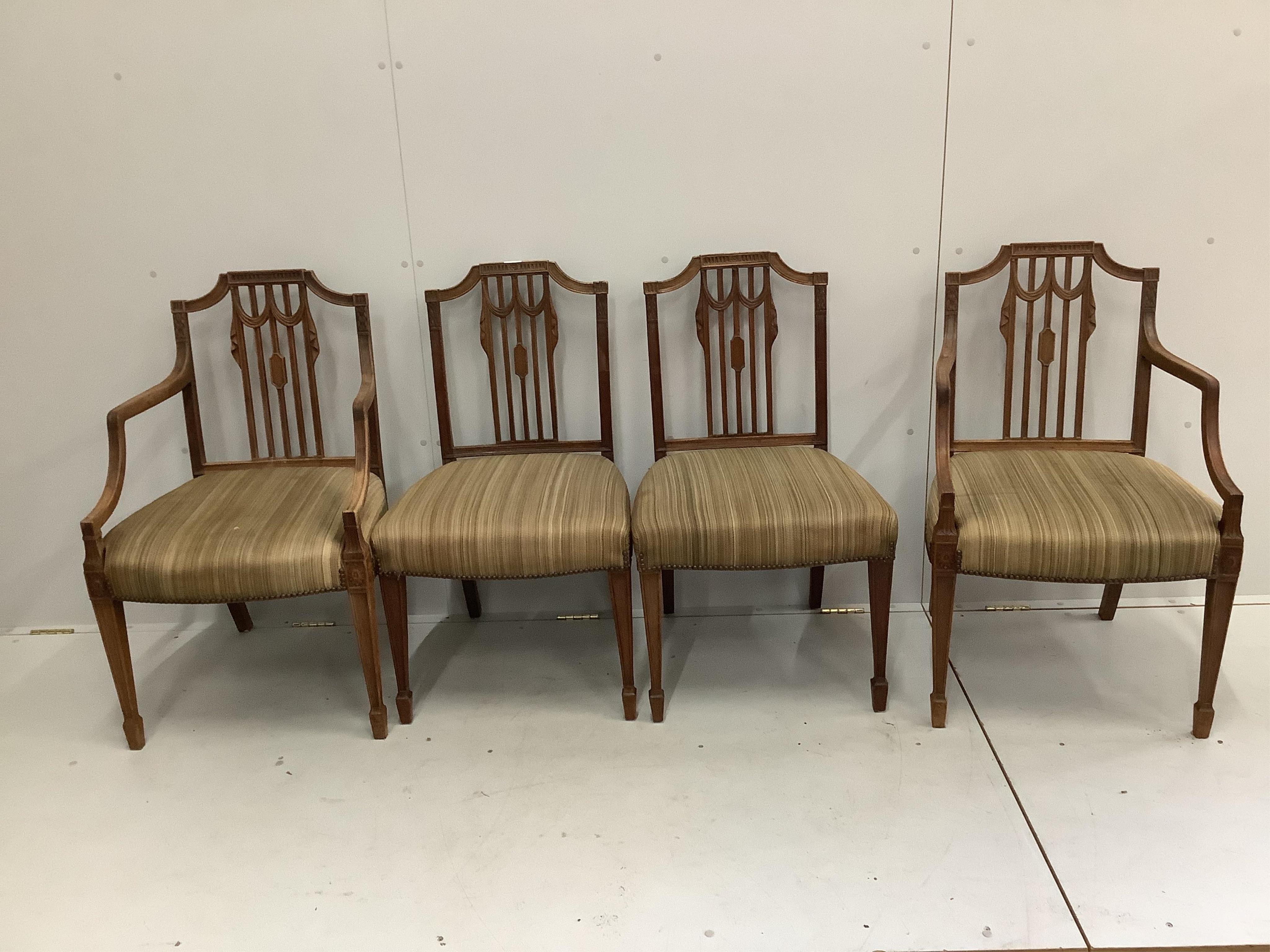 A set of seven Sheraton style mahogany dining chairs, two with arms, width 56cm, depth 50cm, height 91cm. Condition - fair
